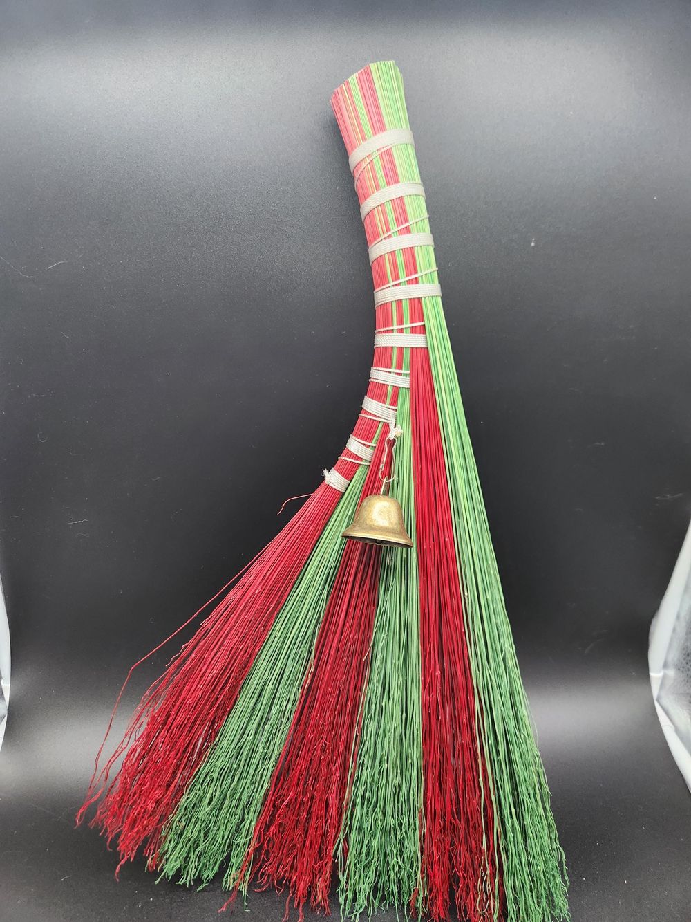 Red and green handmade broom