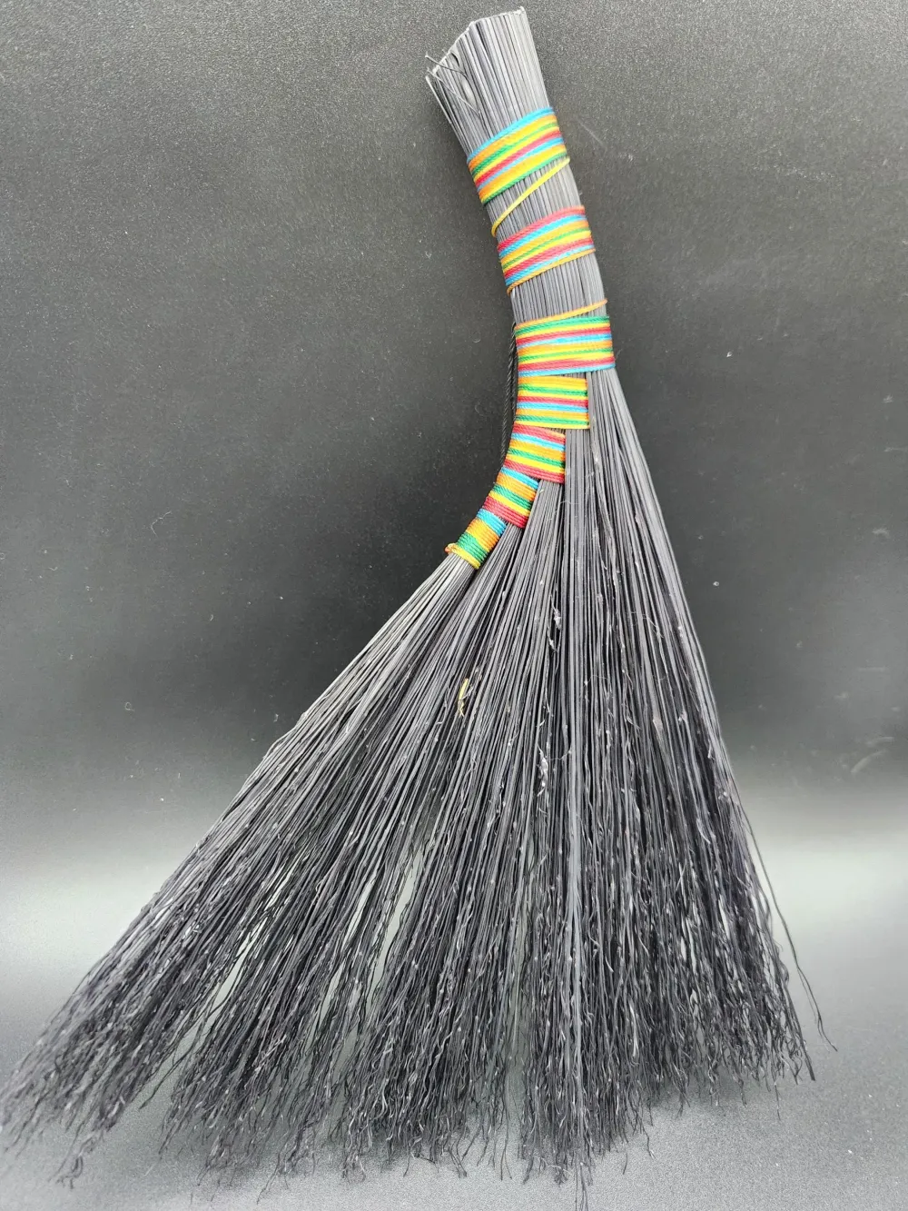 Handmade black broom with rainbow thread