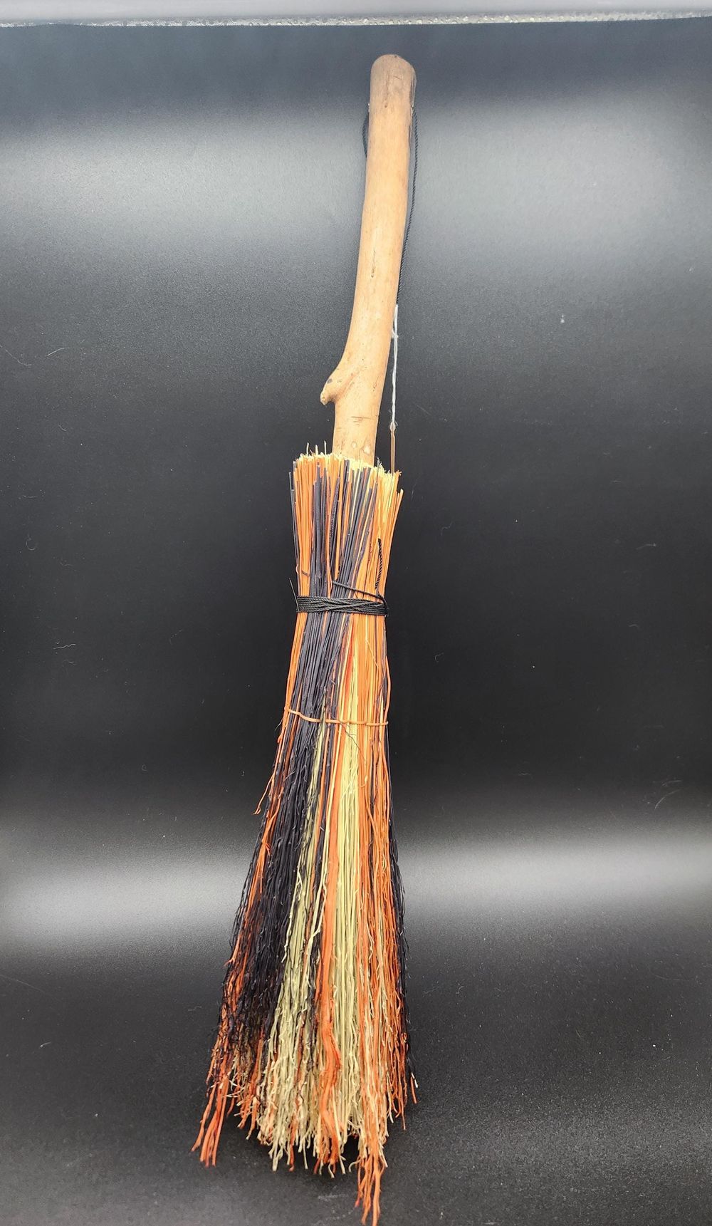 Natural, orange, and black handmade witch's broom