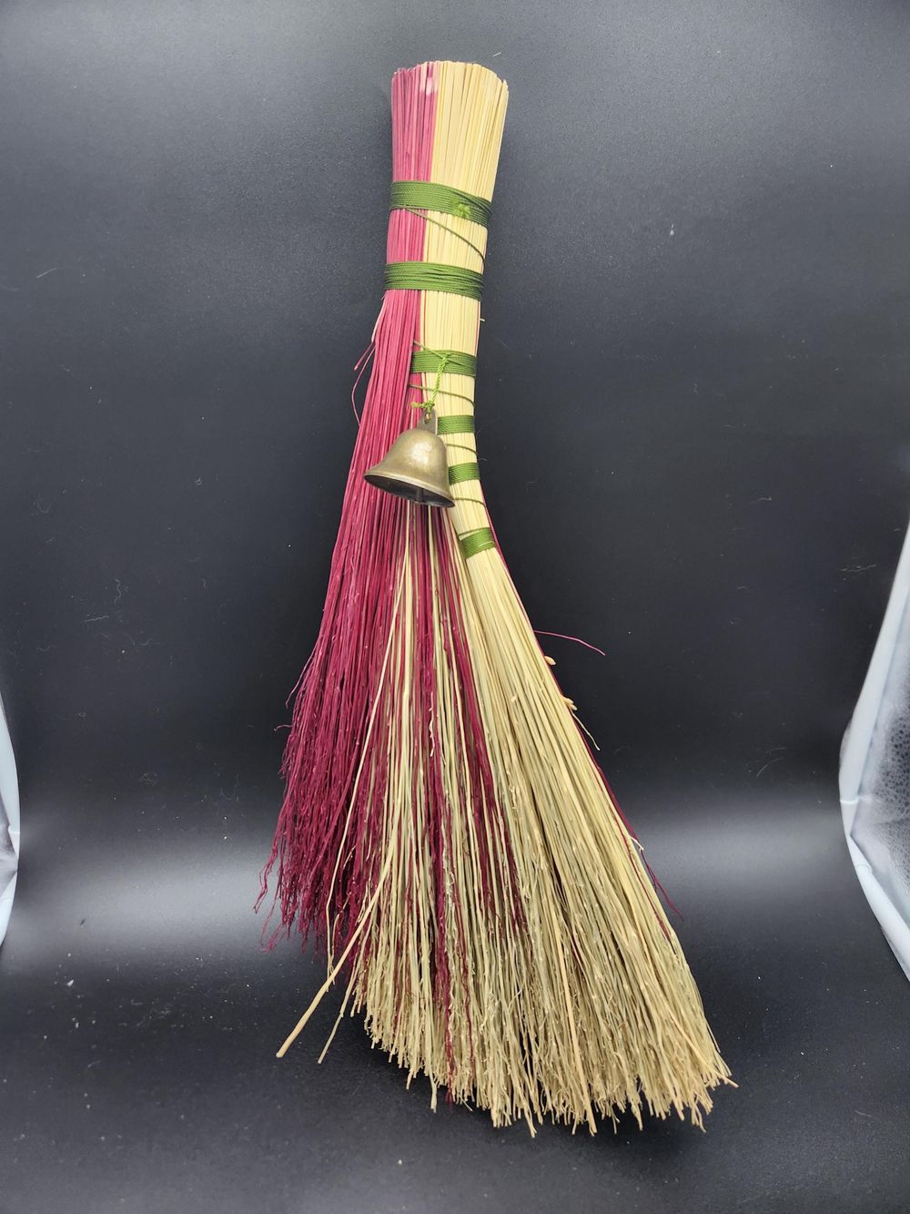 Red and green handmade broom