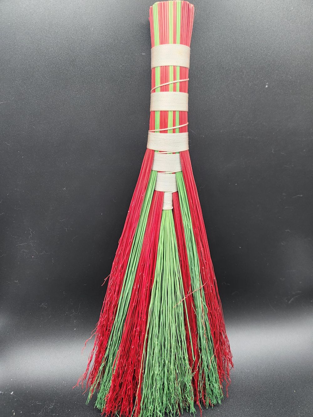 Red and green handmade broom