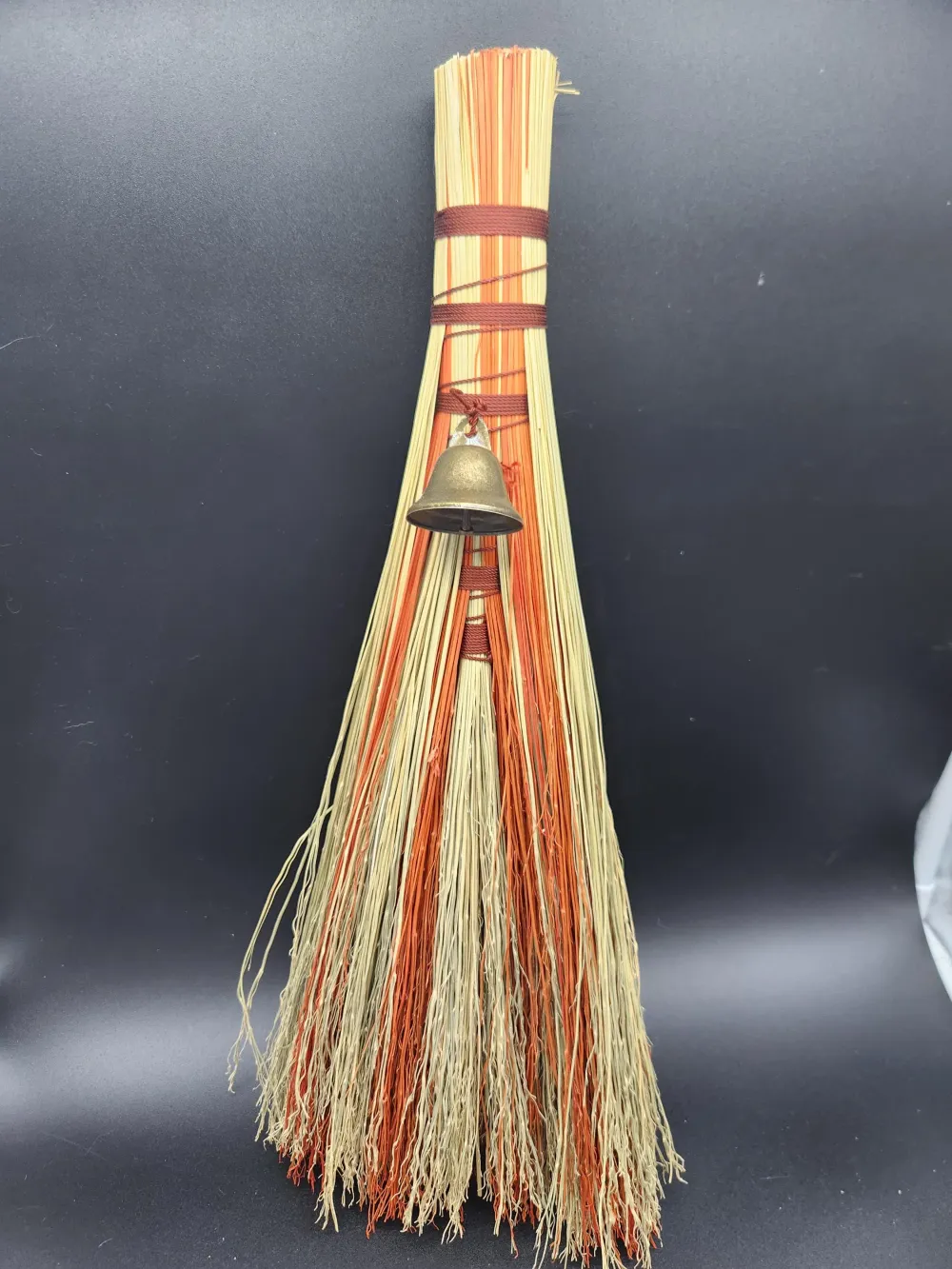 Natural and orange handmade broom